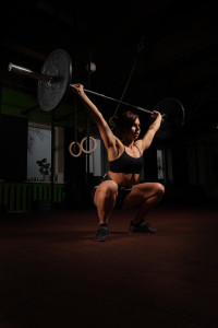 Woman lifting weight in gym