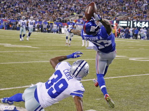 New York Giants wide receiver Odell Beckham (13) makes a spectacular touchdown catch over Dallas Cowboys cornerback Brandon Carr (39)in the second quarter during the Dallas Cowboys vs. the New York Giants NFL football game at MetLife Stadium in east Rutherford, New Jersey on Sunday, November 23, 2014. (Louis DeLuca/The Dallas Morning News)
